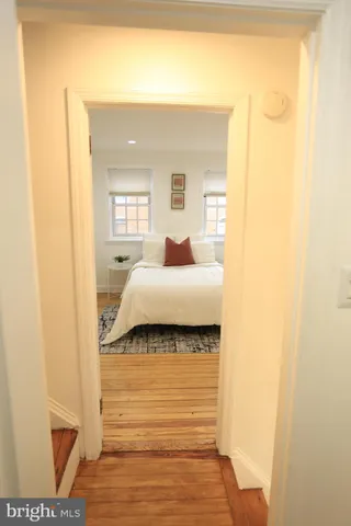 a bedroom with a bed and a mirror