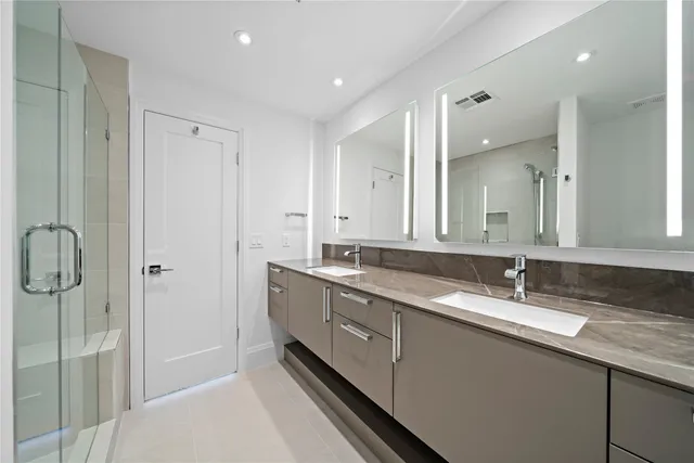 a bathroom with a double vanity sink and mirror
