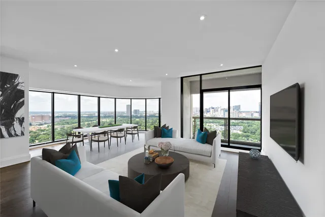 a living room with furniture and a floor to ceiling window