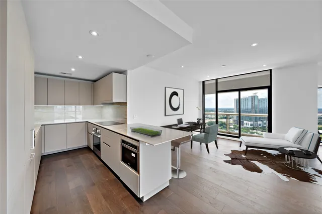 a kitchen with a stove and white cabinets