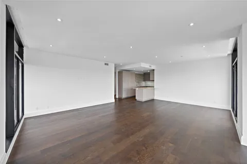 a view of a kitchen with a sink and a refrigerator