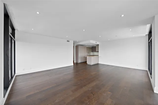 a view of a kitchen with a sink and a refrigerator