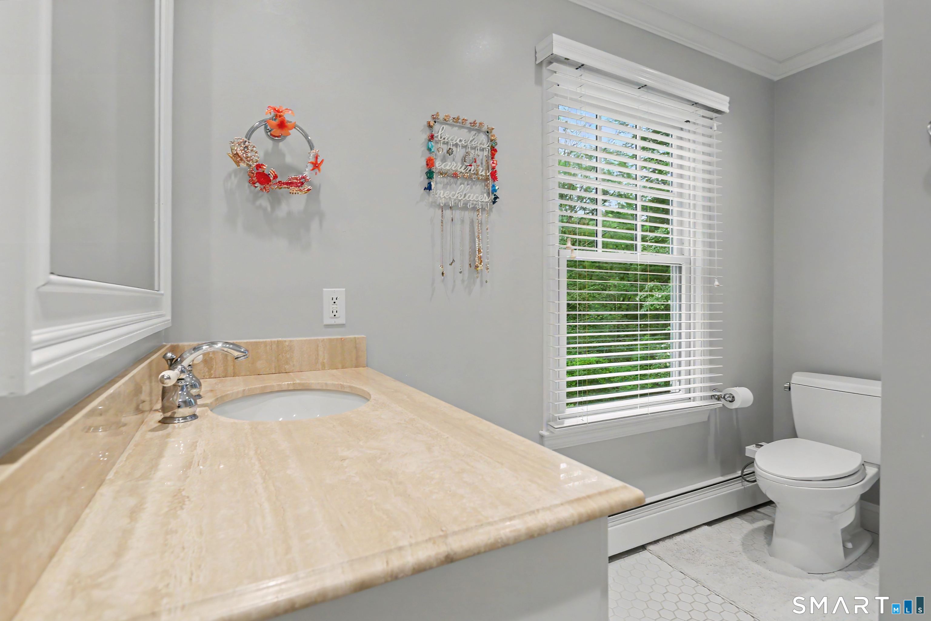 108 Logan Road New Canaan, CT 06840 - Photo 26 of 40 a bathroom with a sink a toilet and a window