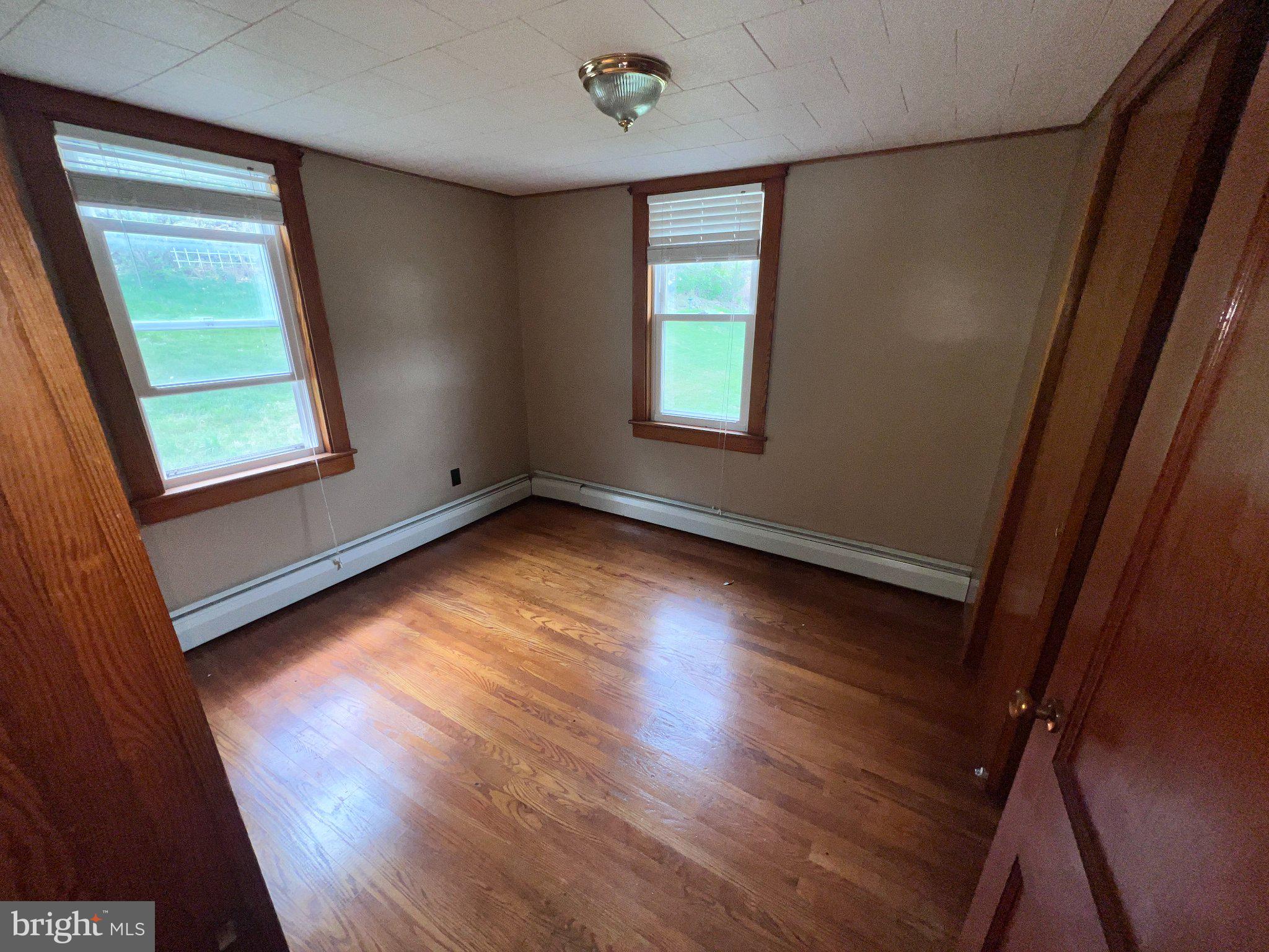 22416 Seldom Seen Road Southwest Lonaconing, MD 21539 - Photo 15 of 39 an empty room with wooden floor and windows