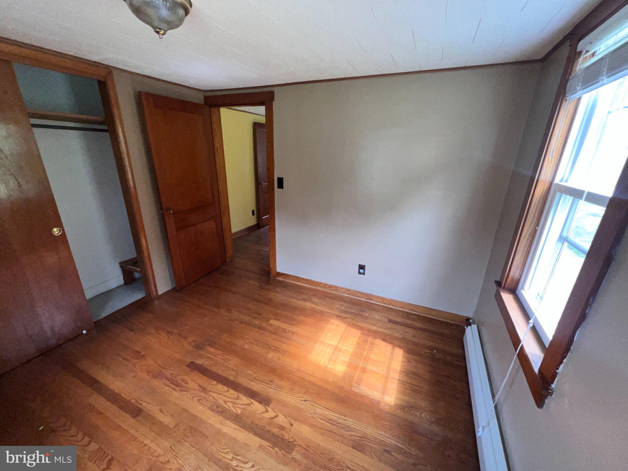 22416 Seldom Seen Road Southwest Lonaconing, MD 21539 - Photo 16 of 39 a view of empty room with wooden floor and fan