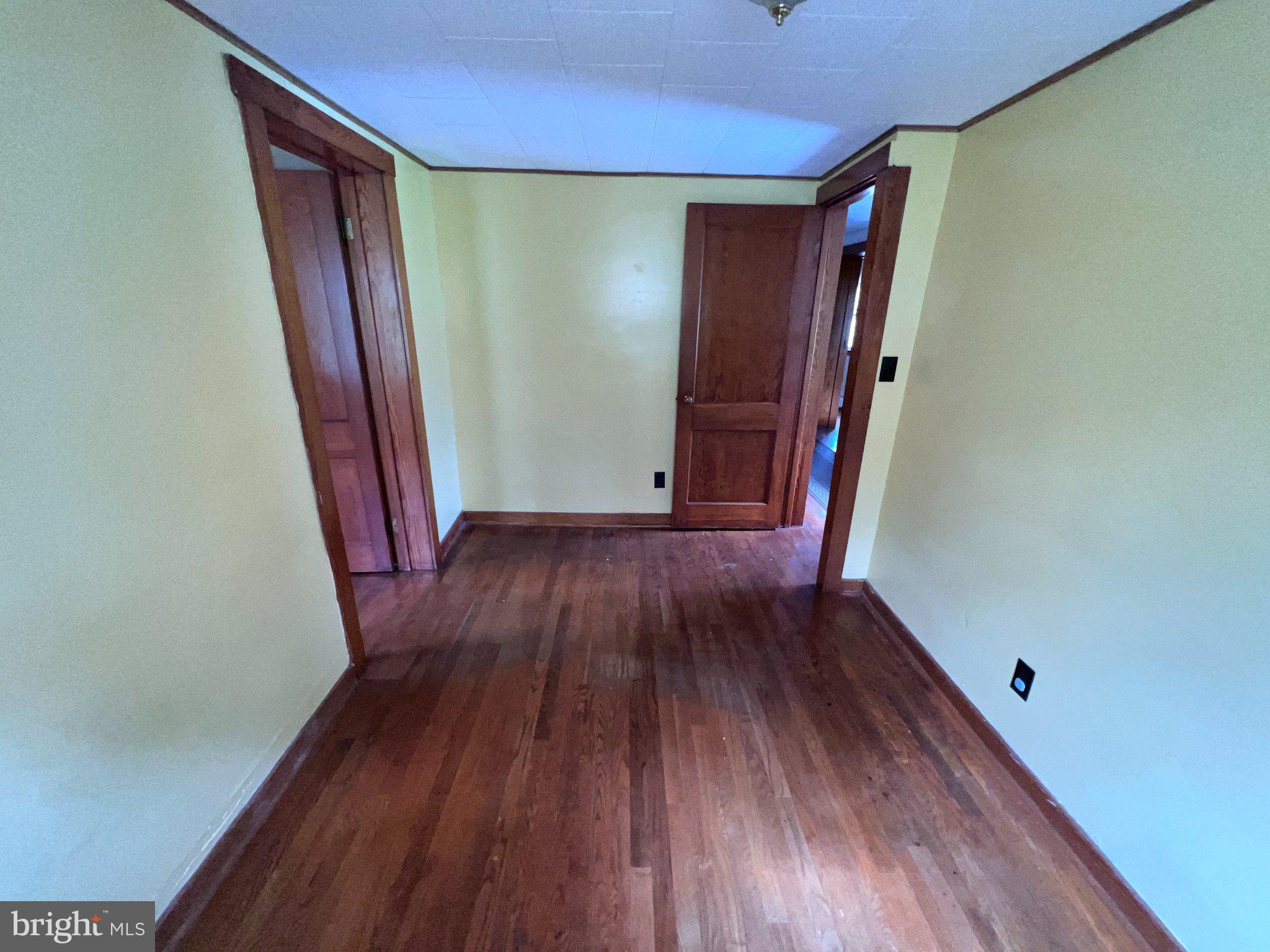 22416 Seldom Seen Road Southwest Lonaconing, MD 21539 - Photo 18 of 39 a view of empty room with wooden floor and stairs