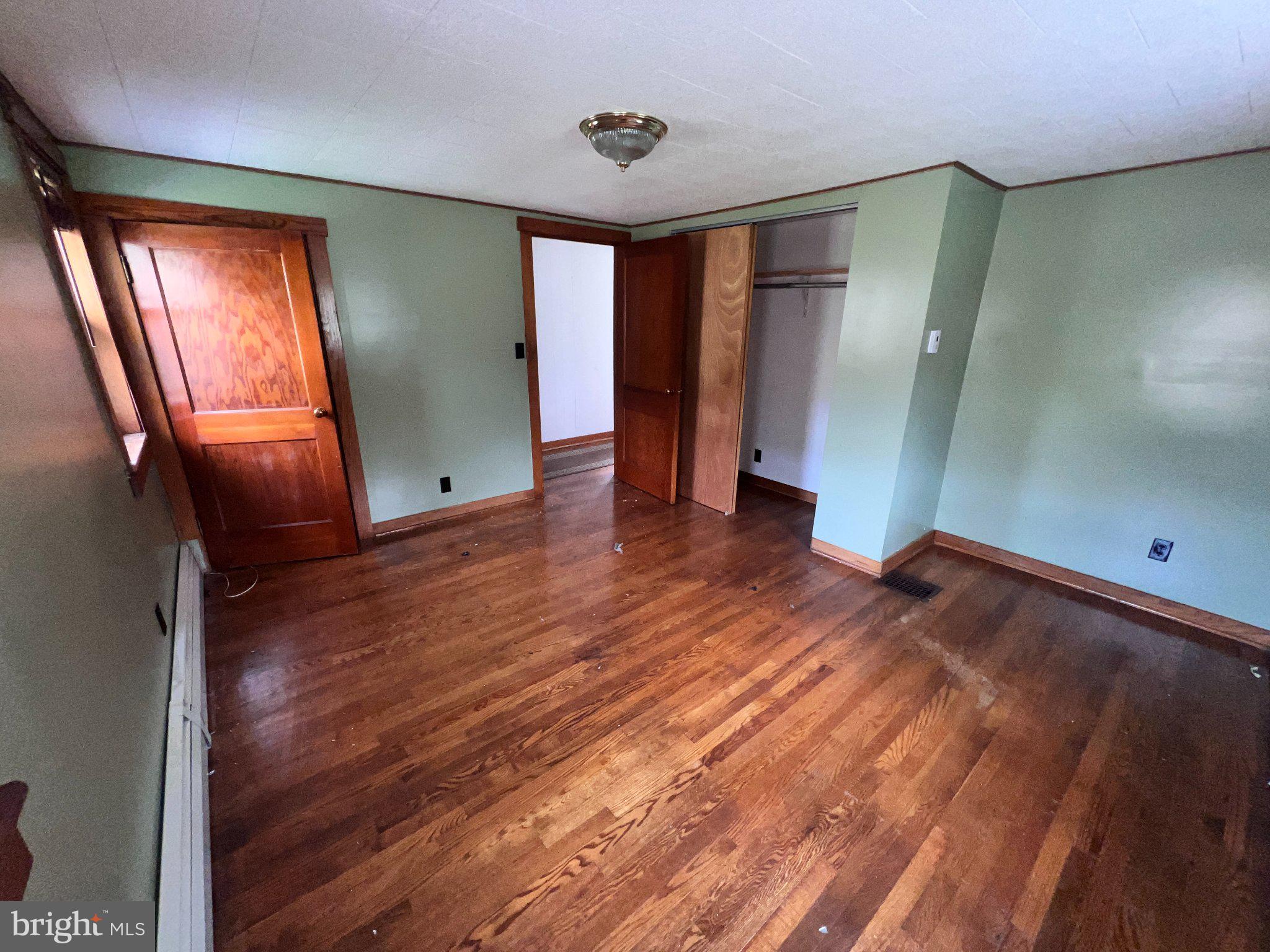 22416 Seldom Seen Road Southwest Lonaconing, MD 21539 - Photo 20 of 39 wooden floor in an empty room