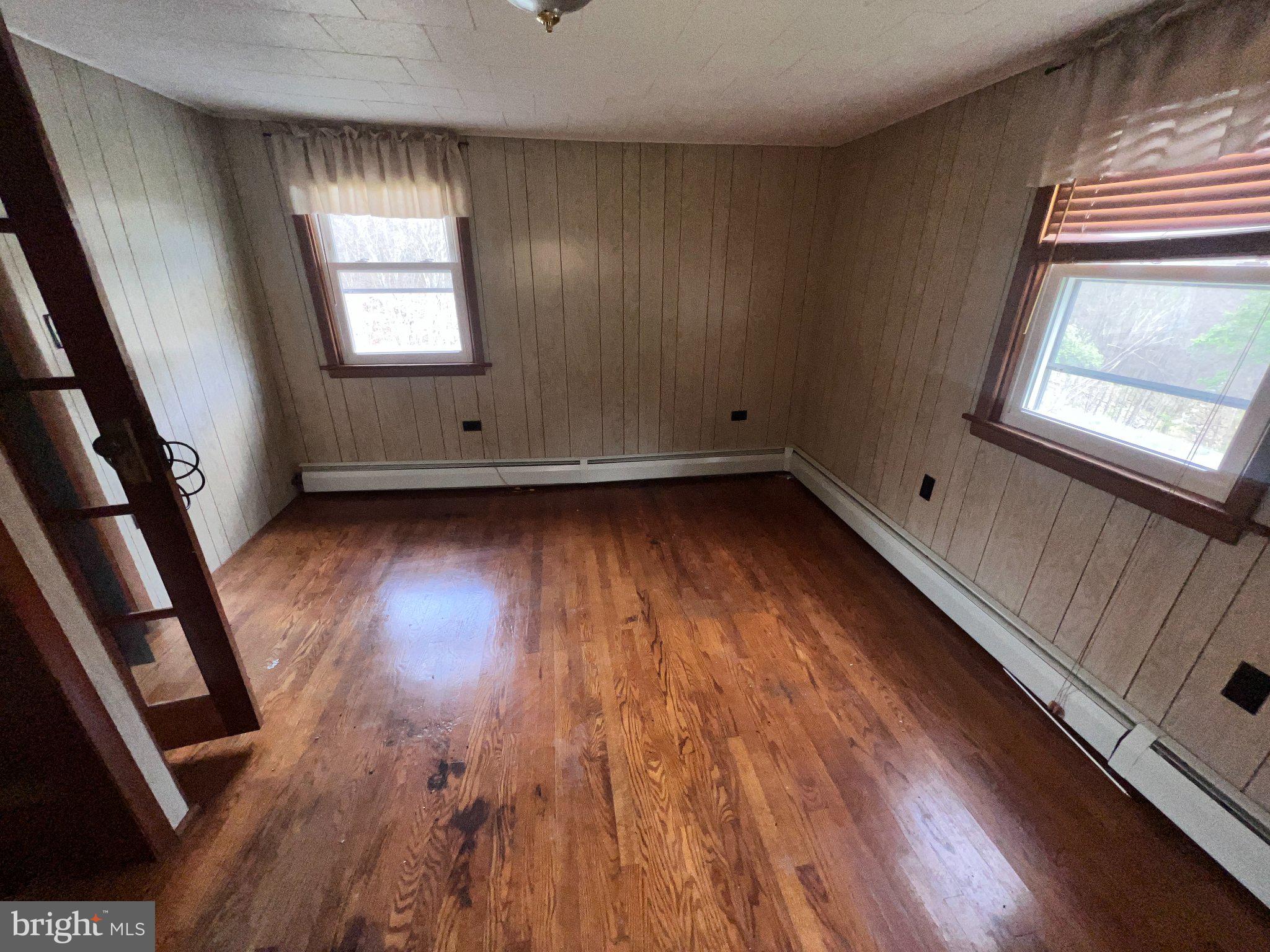 22416 Seldom Seen Road Southwest Lonaconing, MD 21539 - Photo 23 of 39 a view of an empty room with wooden floor and a window