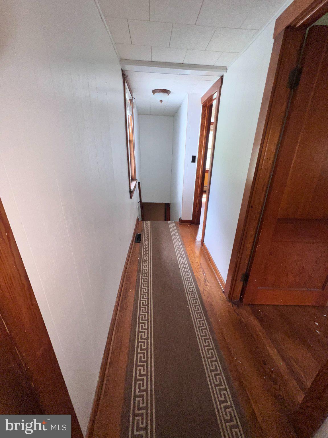 22416 Seldom Seen Road Southwest Lonaconing, MD 21539 - Photo 24 of 39 a view of a hallway with wooden floor and stairs