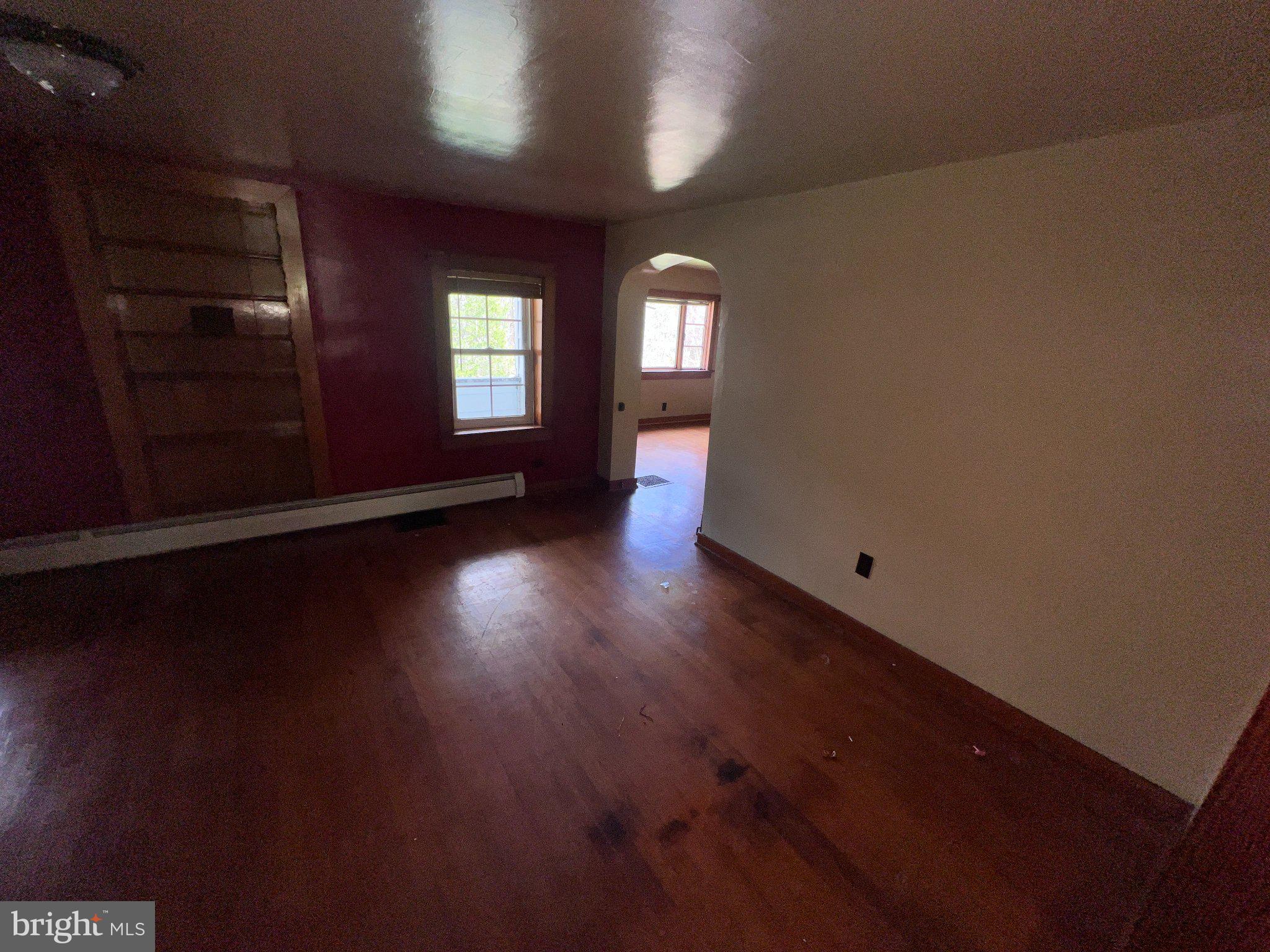 22416 Seldom Seen Road Southwest Lonaconing, MD 21539 - Photo 8 of 39 an empty room with wooden floor and windows