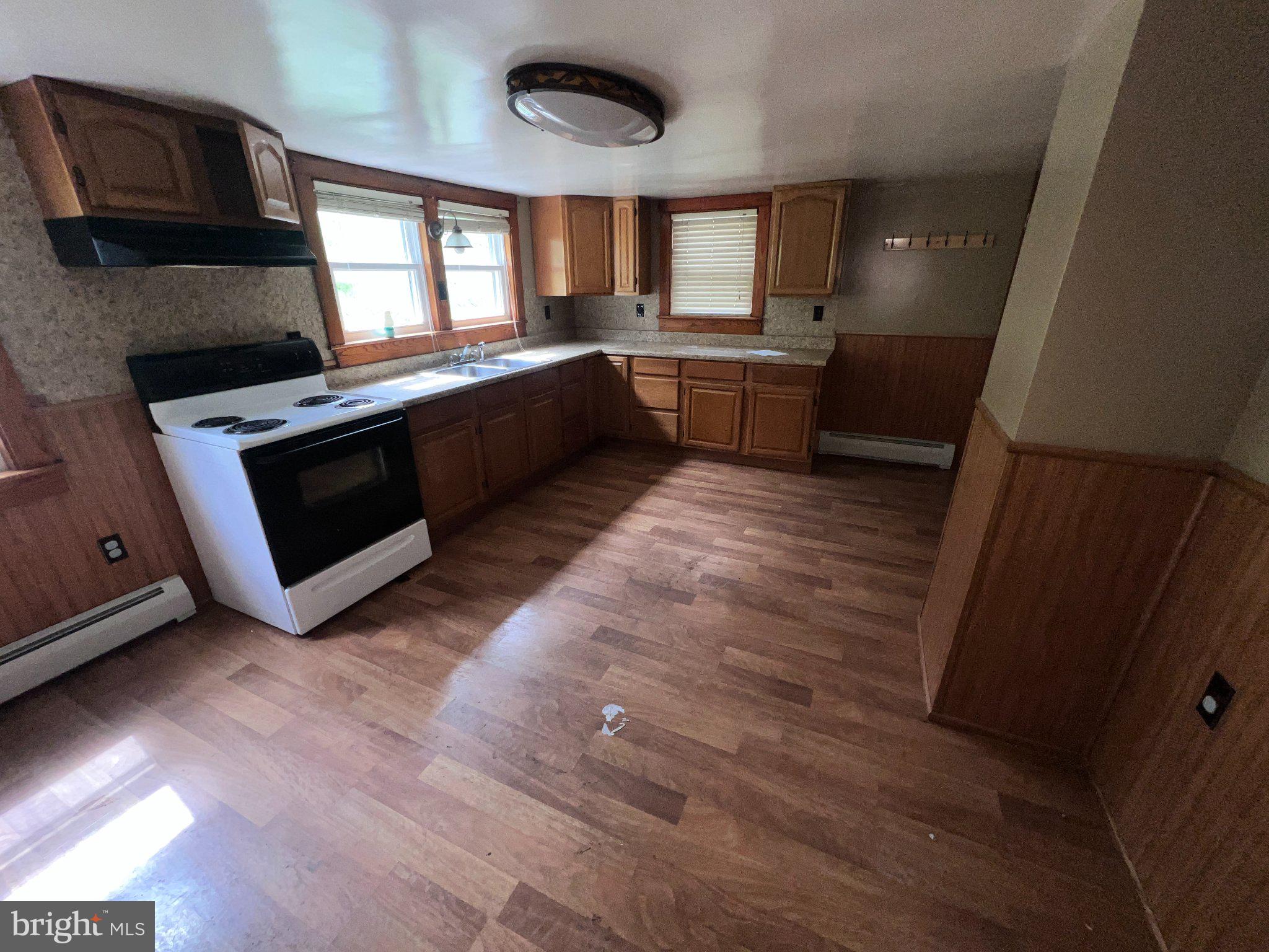 22416 Seldom Seen Road Southwest Lonaconing, MD 21539 - Photo 10 of 39 a large kitchen with a stove a sink dishwasher and a fireplace
