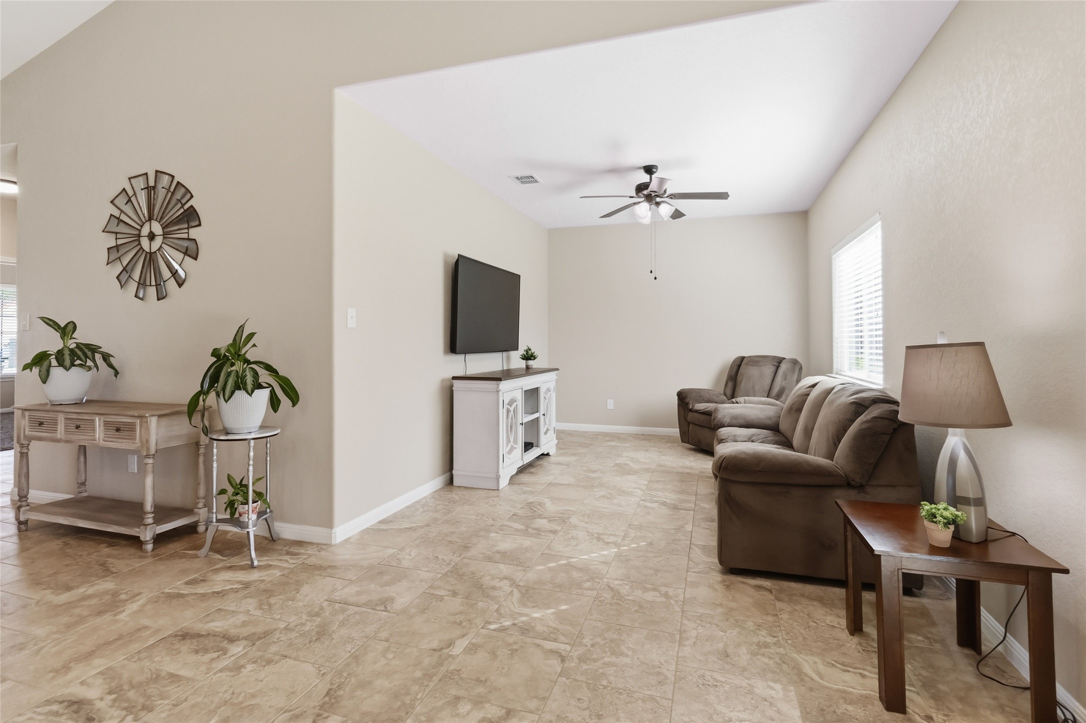 285 Hummingbird Way Martindale, TX 78655 - Photo 16 of 40 a living room with furniture a chandelier and a flat screen tv