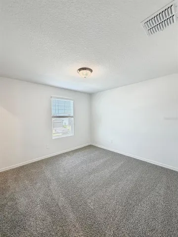 an empty room with a empty space and windows