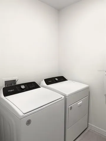 a view of an empty room with a cabinet and mirrors