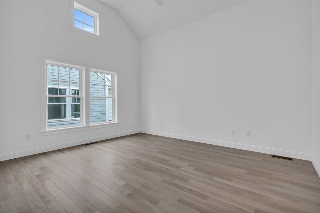 47 Cobblestone Circle Mashpee, MA 02649 - Photo 14 of 25 an empty room with wooden floor and windows