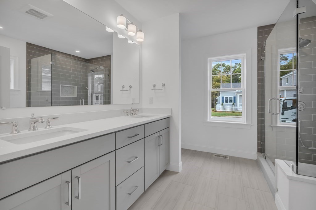 47 Cobblestone Circle Mashpee, MA 02649 - Photo 17 of 25 a bathroom with a double vanity sink and a mirror