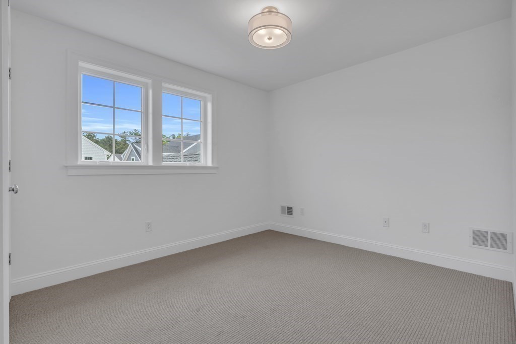 47 Cobblestone Circle Mashpee, MA 02649 - Photo 20 of 25 an empty room with a window