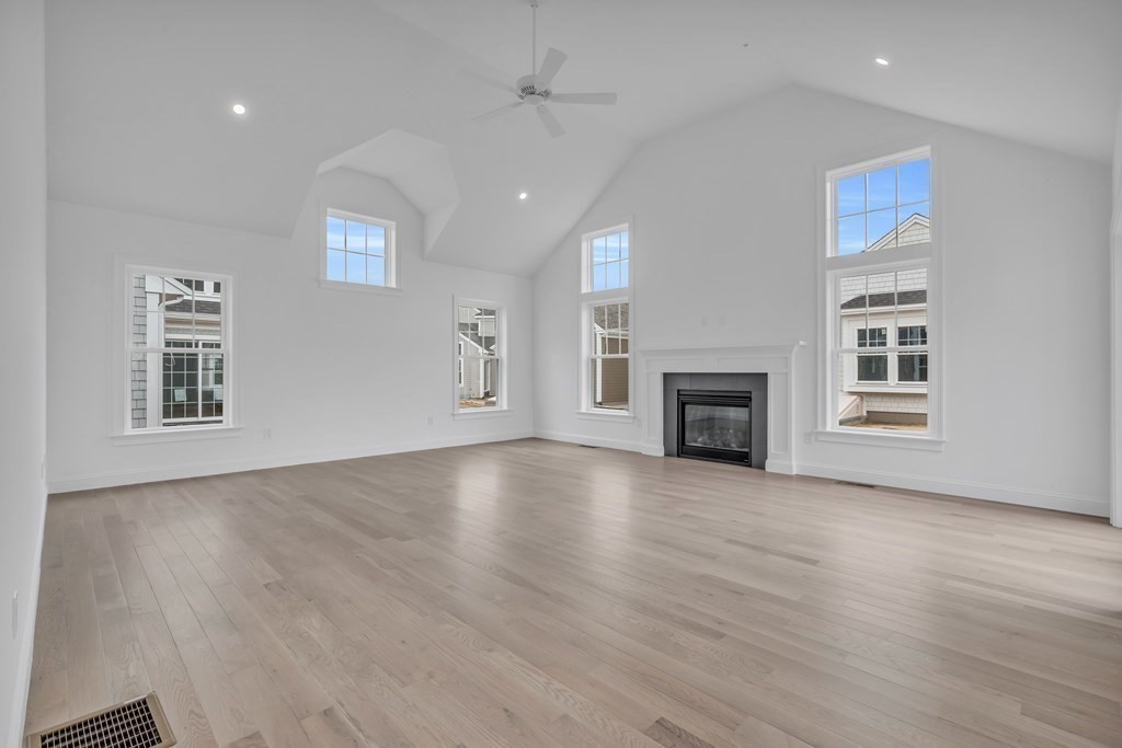 47 Cobblestone Circle Mashpee, MA 02649 - Photo 3 of 25 an empty room with windows and fireplace