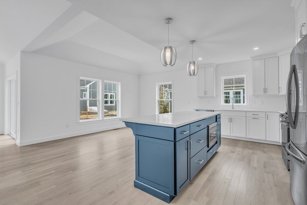 47 Cobblestone Circle Mashpee, MA 02649 - Photo 6 of 25 a kitchen with stainless steel appliances granite countertop a sink a counter space and wooden floor
