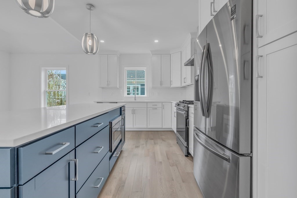 47 Cobblestone Circle Mashpee, MA 02649 - Photo 9 of 25 a kitchen with stainless steel appliances a refrigerator sink and cabinets