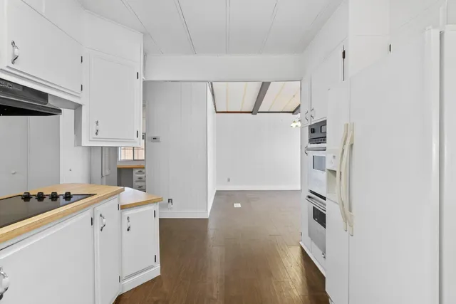 a kitchen with stainless steel appliances a refrigerator and a stove top oven