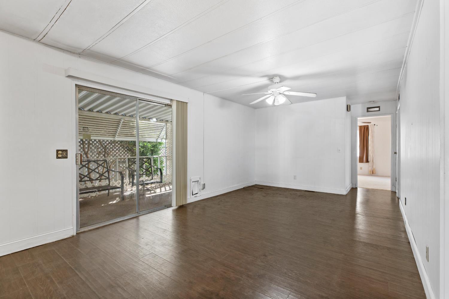 1200 South Carpenter Road, Unit 18 Modesto, CA 95351 - Photo 13 of 30 wooden floor in an empty room with a window