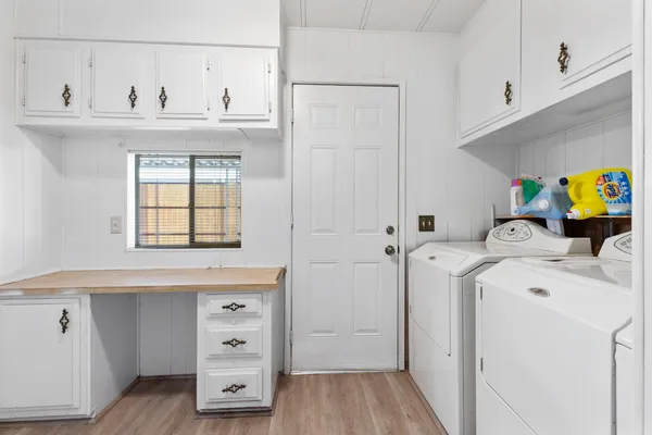 a view of washer and dryer with wooden floor
