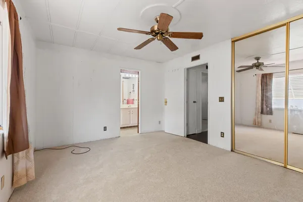 a view of a livingroom with a ceiling fan & a ceiling fan