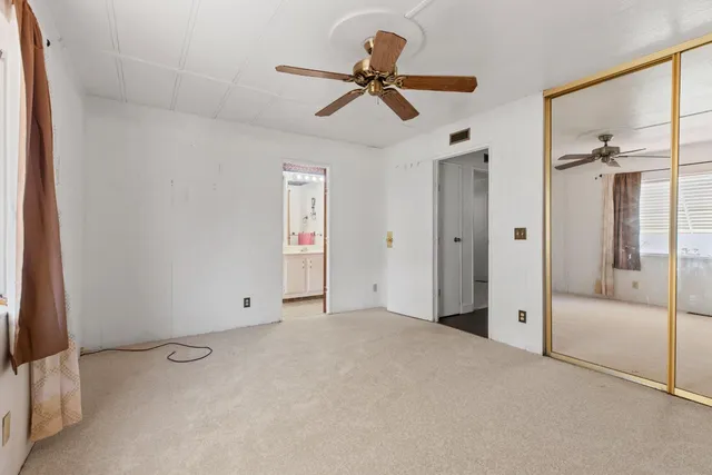 a view of a livingroom with a ceiling fan & a ceiling fan