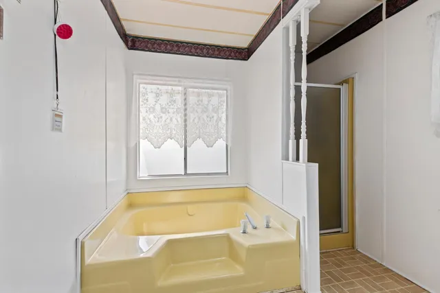 a bathroom with a tub and shower