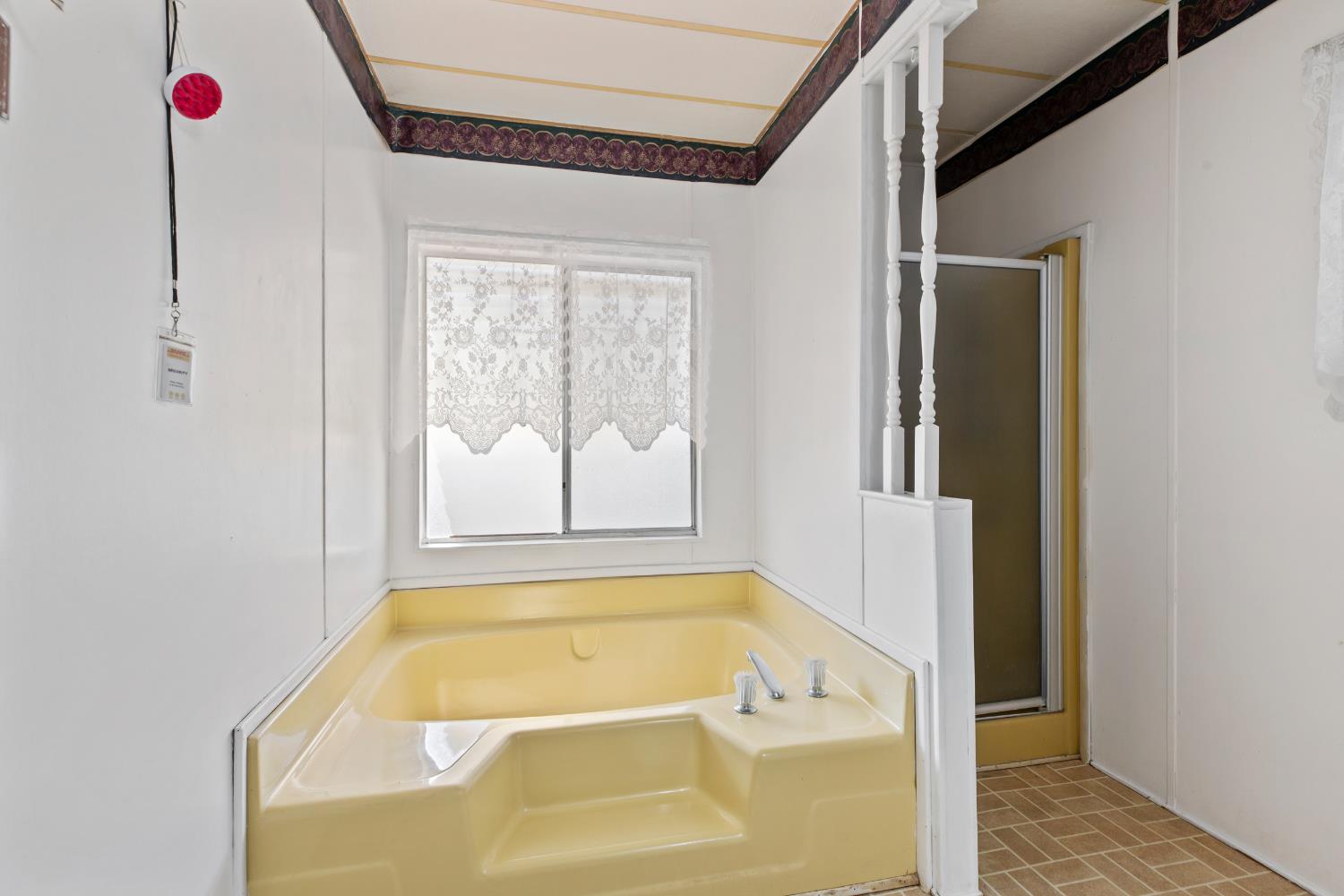 1200 South Carpenter Road, Unit 18 Modesto, CA 95351 - Photo 19 of 30 a bathroom with a tub and shower