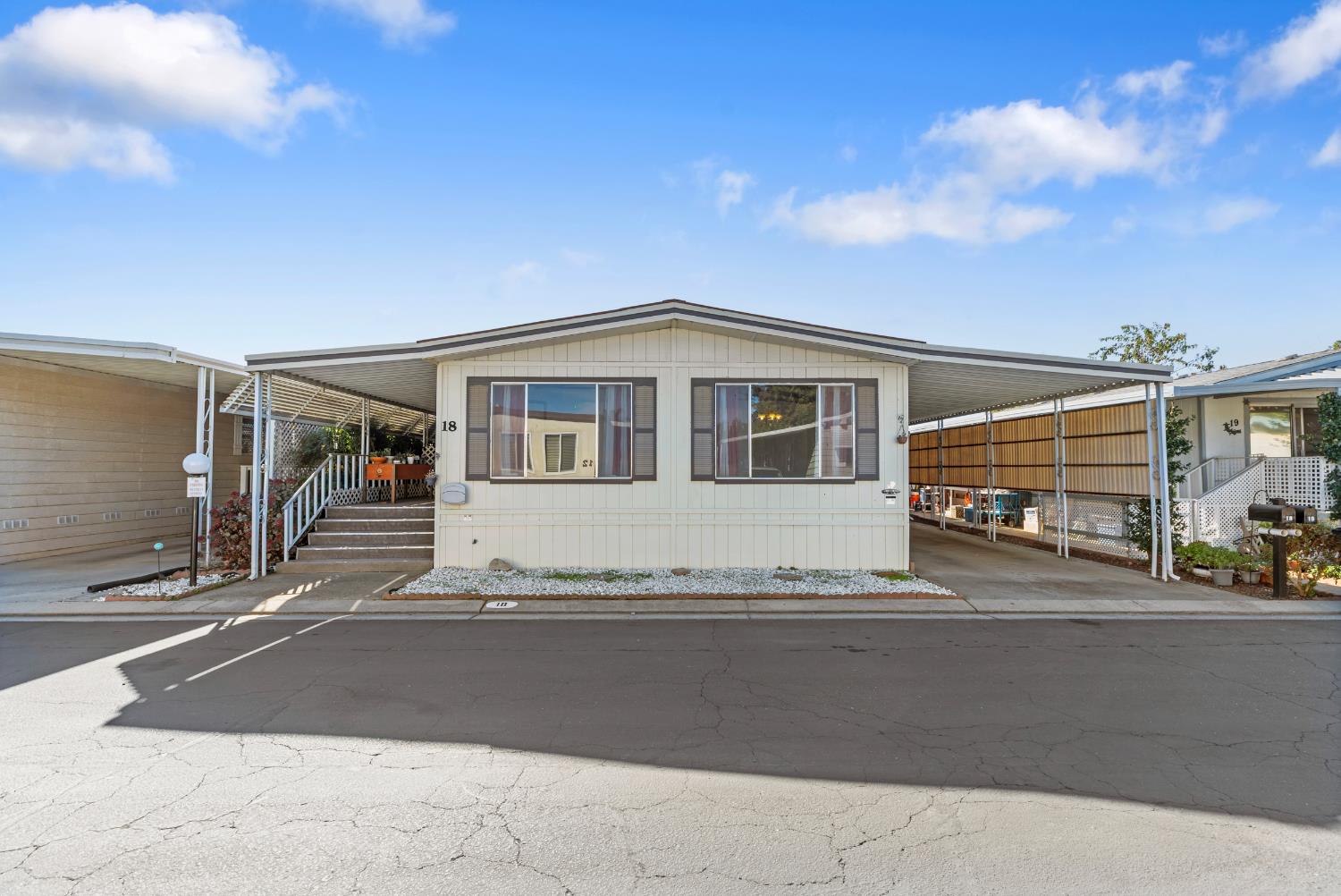 1200 South Carpenter Road, Unit 18 Modesto, CA 95351 - Photo 2 of 30 a front view of a house with a garage