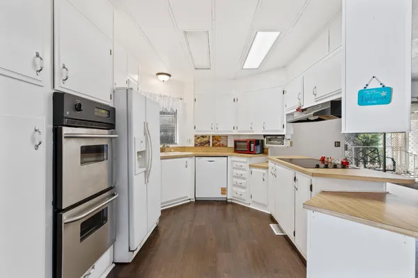 a kitchen with cabinets and stainless steel appliances