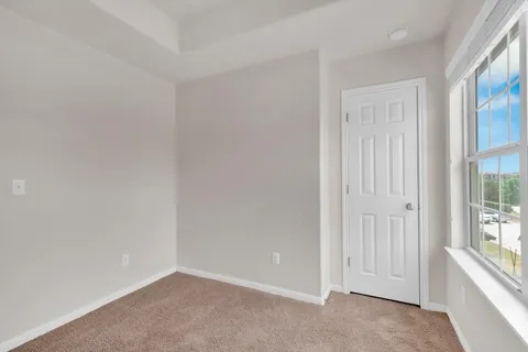 a bathroom with a toilet a sink a mirror a vanity and window