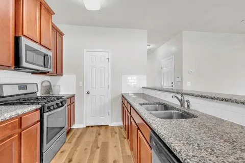 a kitchen that has a sink and a stove