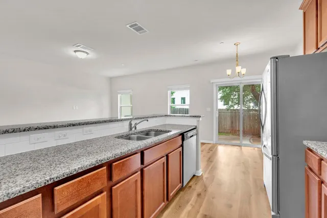 a bathroom with a granite countertop sink and a large mirror