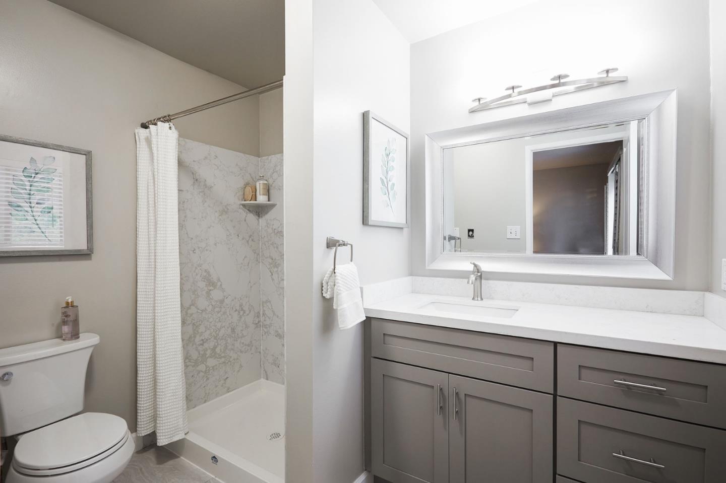 1015 Sycamore Drive Millbrae, CA 94030 - Photo 12 of 26 a bathroom with a toilet sink vanity shower and mirror