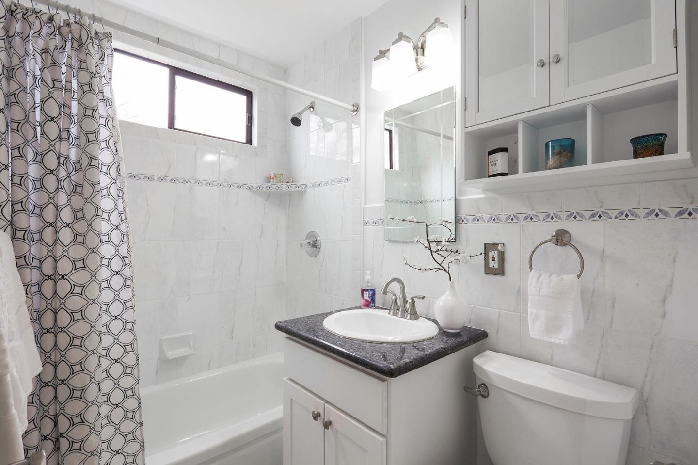 1015 Sycamore Drive Millbrae, CA 94030 - Photo 17 of 26 a bathroom with a granite countertop sink toilet and shower