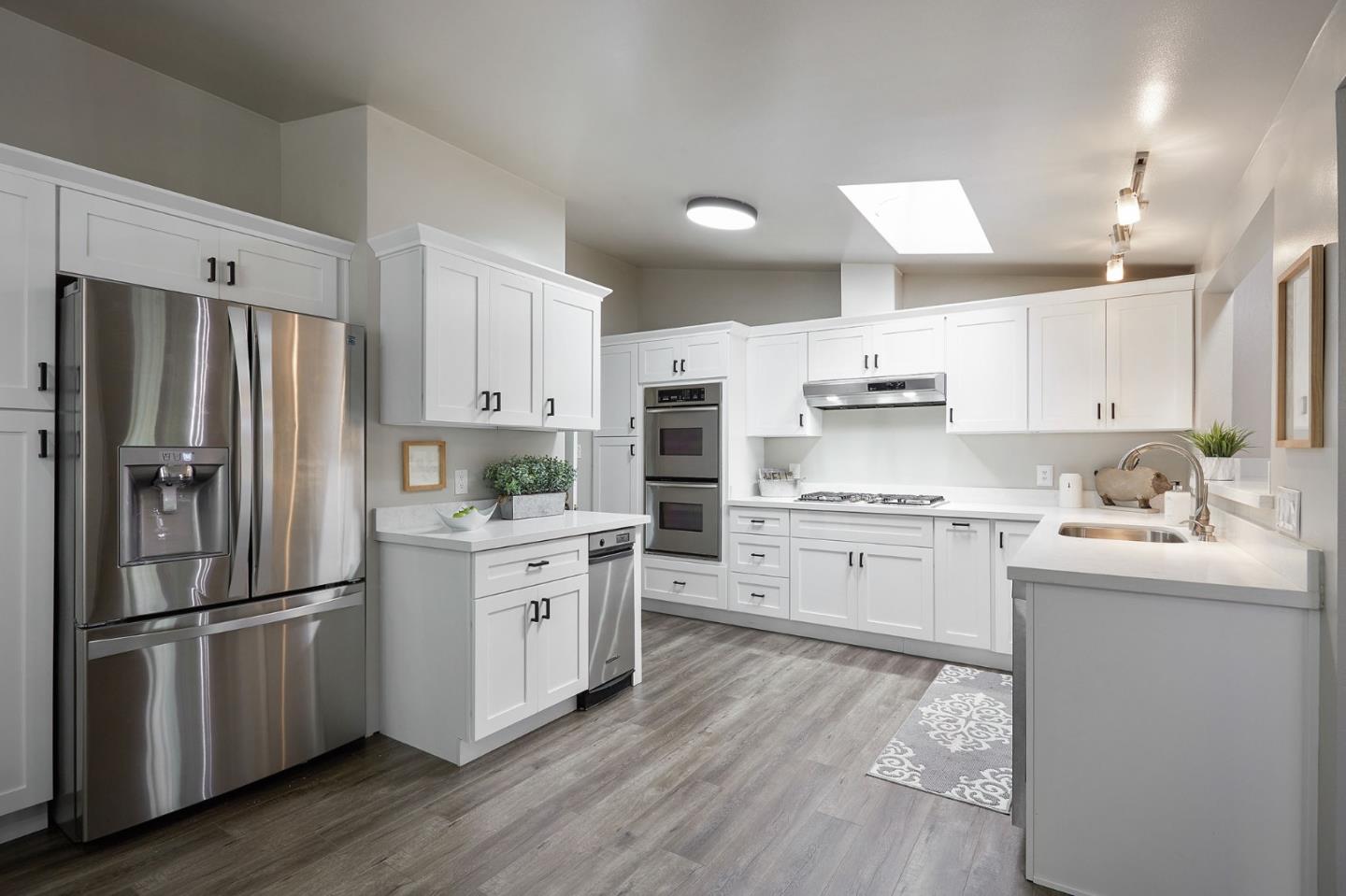 1015 Sycamore Drive Millbrae, CA 94030 - Photo 5 of 26 a kitchen with stainless steel appliances a refrigerator sink and microwave