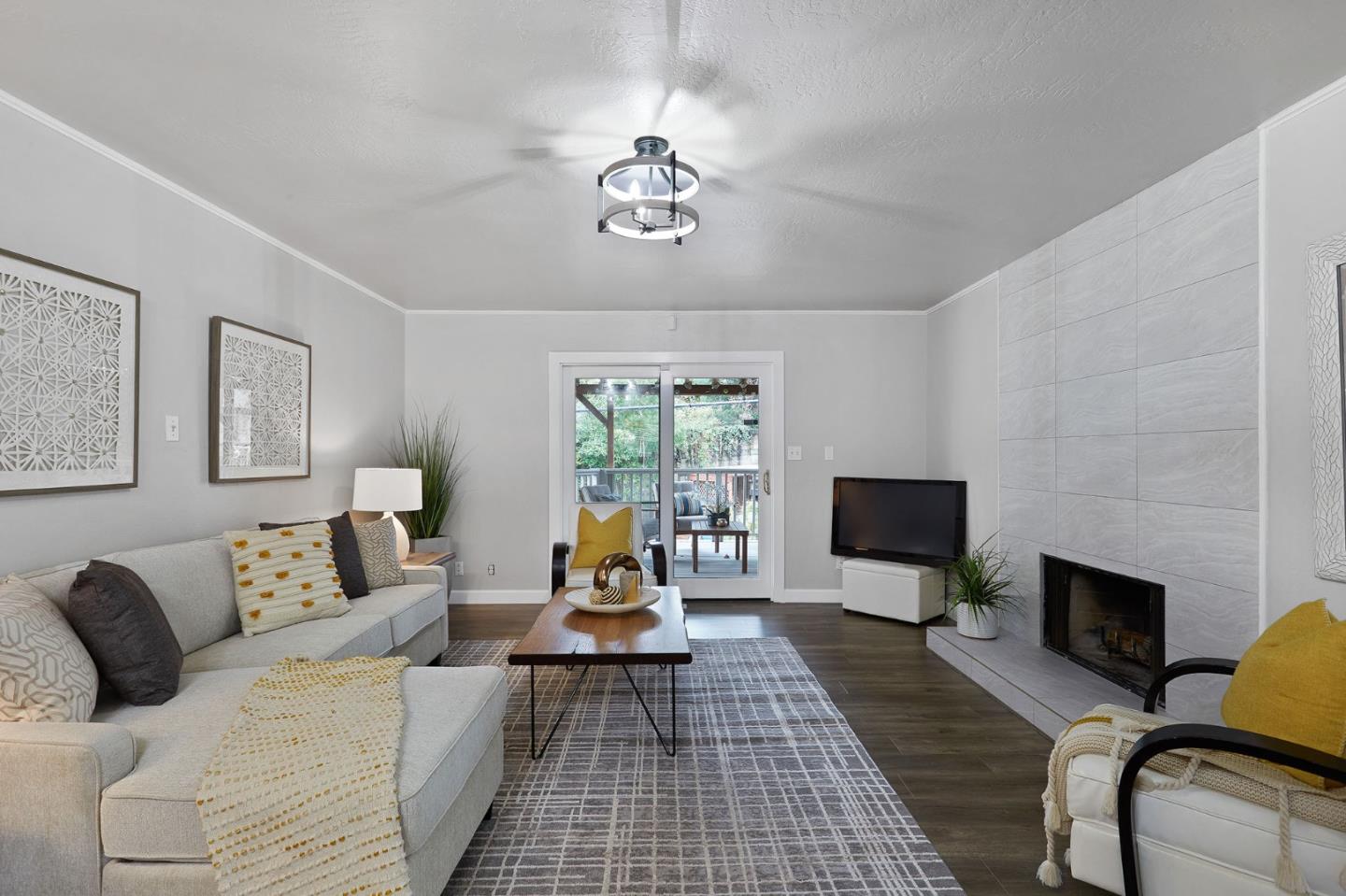 1015 Sycamore Drive Millbrae, CA 94030 - Photo 9 of 26 a living room with furniture a fireplace and a flat screen tv