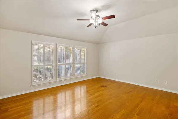 a view of an empty room with a fireplace and a window