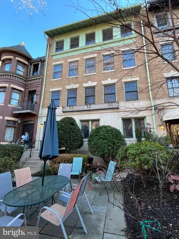a view of a brick building next to a yard
