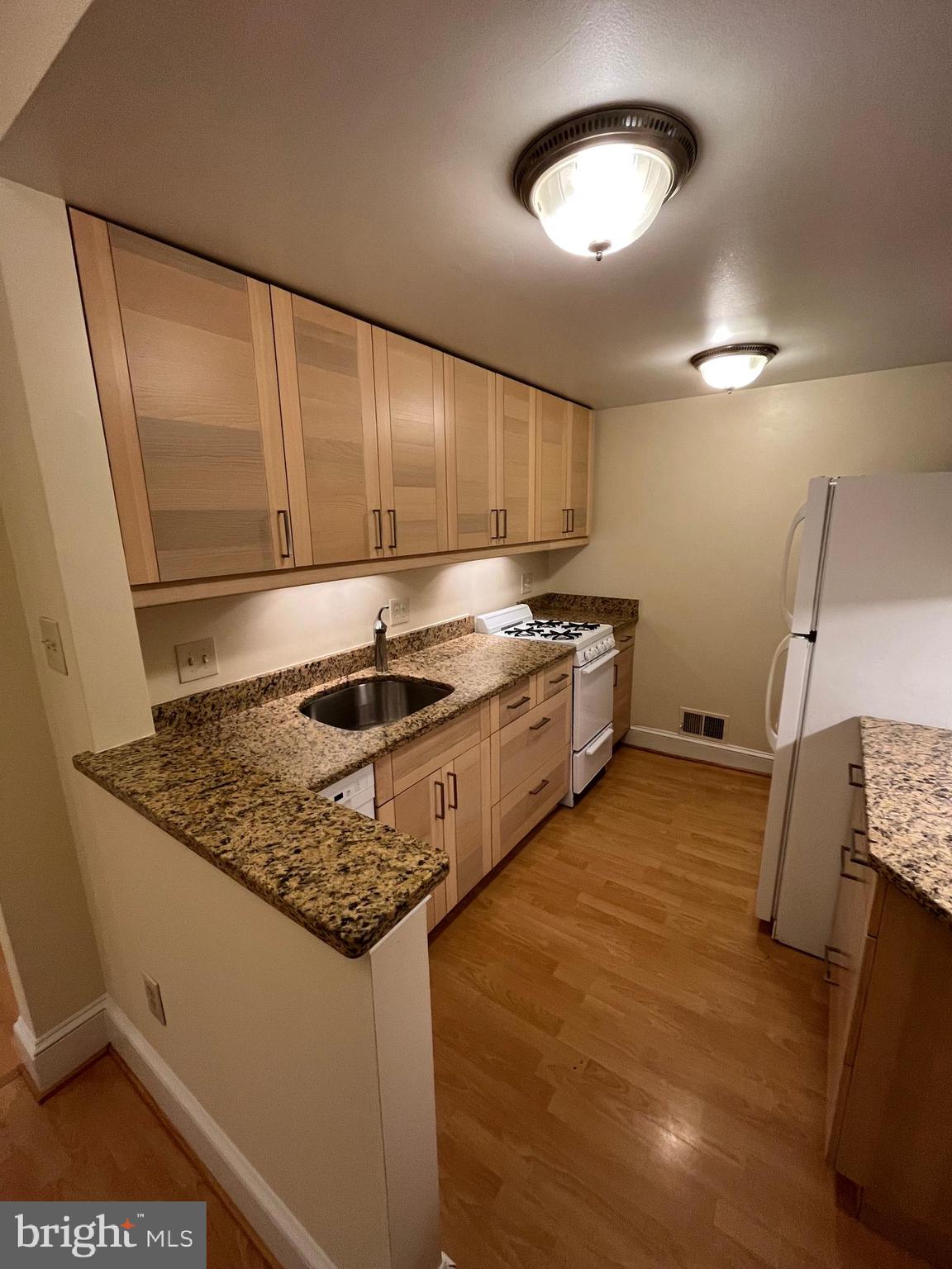 1835 16th Street Northwest, Unit 1 Washington, DC 20009 - Photo 11 of 32 a kitchen with stainless steel appliances granite countertop a sink stove and cabinets