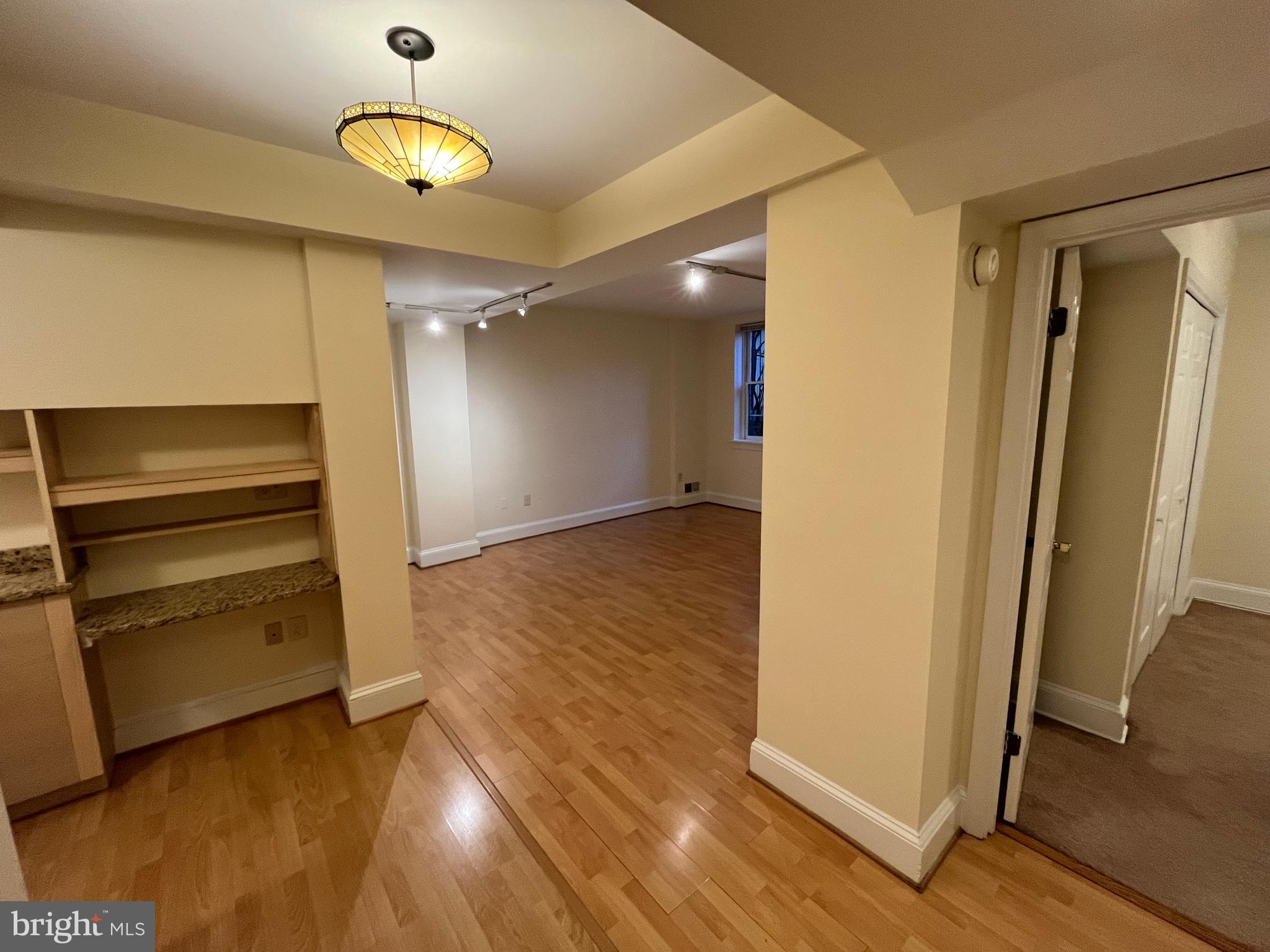 1835 16th Street Northwest, Unit 1 Washington, DC 20009 - Photo 14 of 32 an empty room with wooden floor cabinet and windows