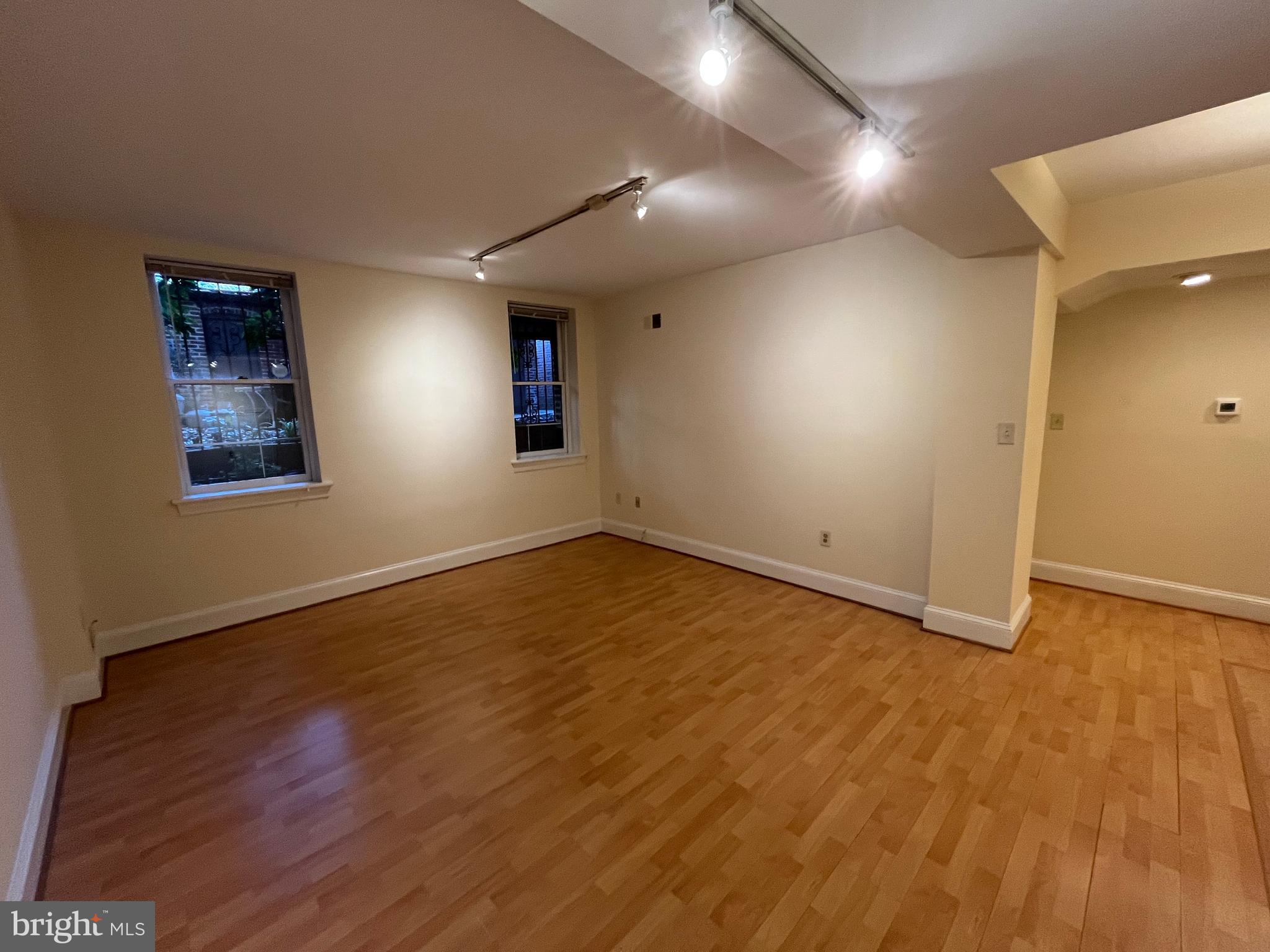1835 16th Street Northwest, Unit 1 Washington, DC 20009 - Photo 16 of 32 an empty room with wooden floor and windows