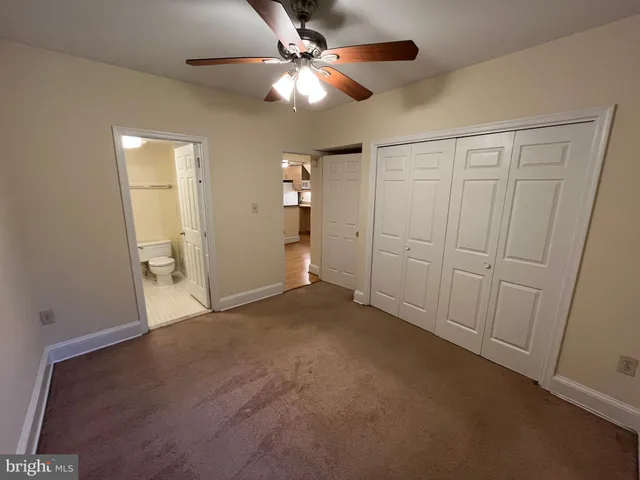 an empty room with fan and entrance
