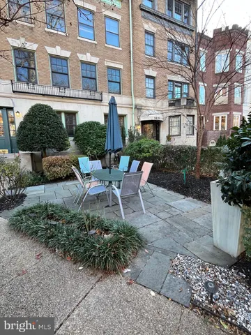 a view of a patio with couches chair and potted plants