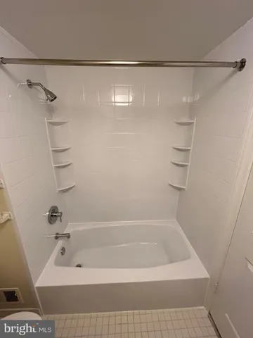 a bathroom with a shower and a bath tub