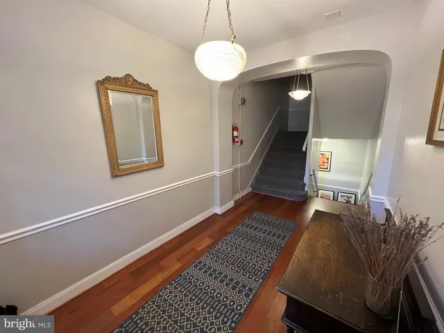 a view of entryway and hall with wooden floor