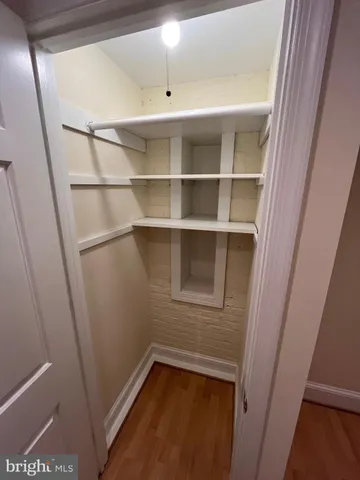 a view of a room with rack on the wall and a window